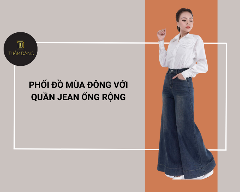 Người mẫu nữ mặc áo sơ mi form rộng màu trắng làm lớp ngoài cho áo crop top và quần jean ống đứng, tạo phong cách layering thời thượng.
