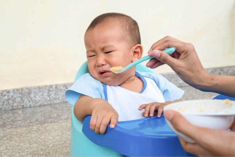 Bé biếng ăn do thiếu sắt với biểu cảm không muốn ăn